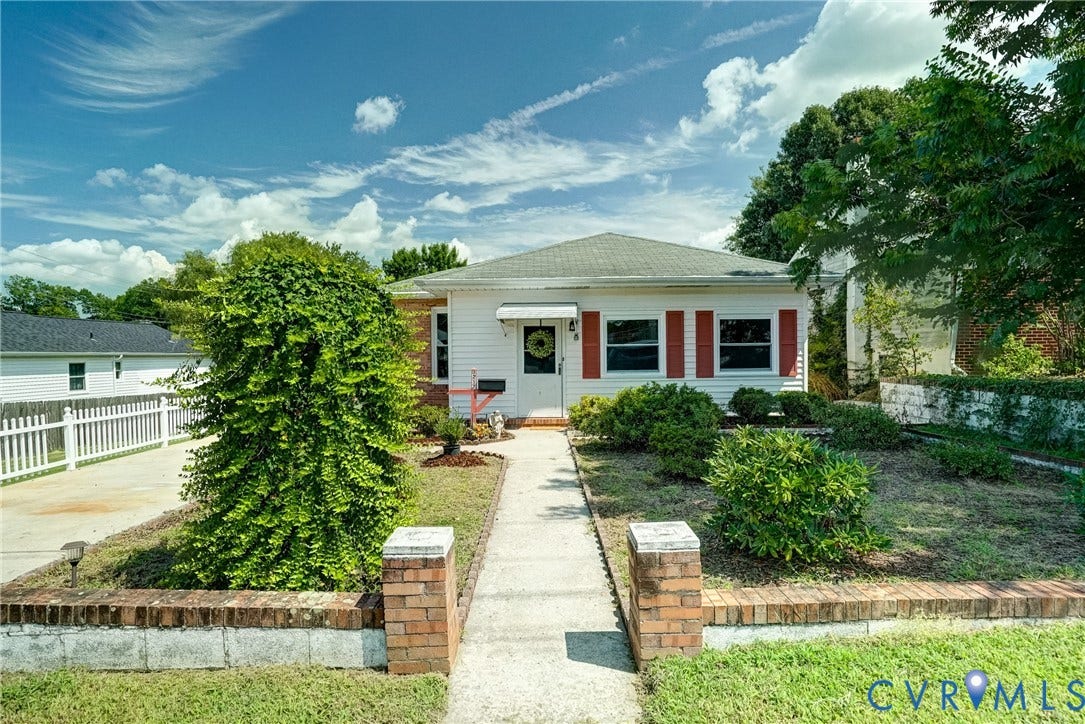 White exterior with red  shutters, covered entry,