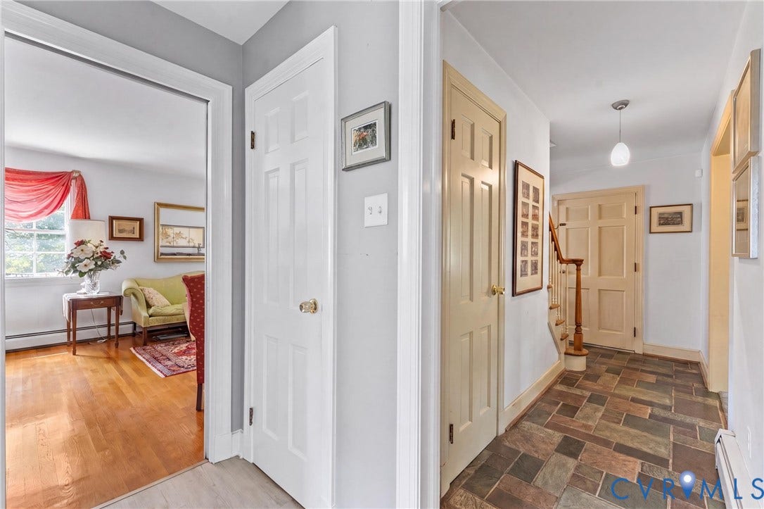 10205 Gwynnbrook Road, Richmond, VA 23235 Hallway featuring multi-toned slate flooring, pendant light fixture, and wood staircase with banister
