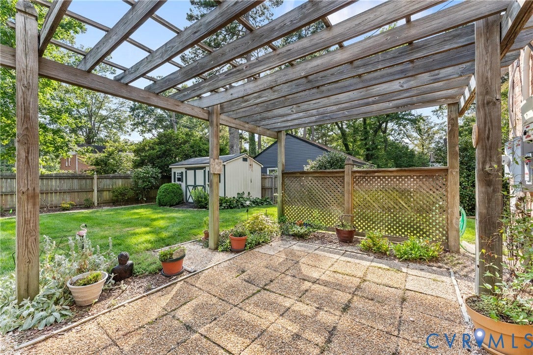10205 Gwynnbrook Road, Richmond, VA 23235 Patio featuring a wood pergola, paver flooring, and decorative lattice fencing