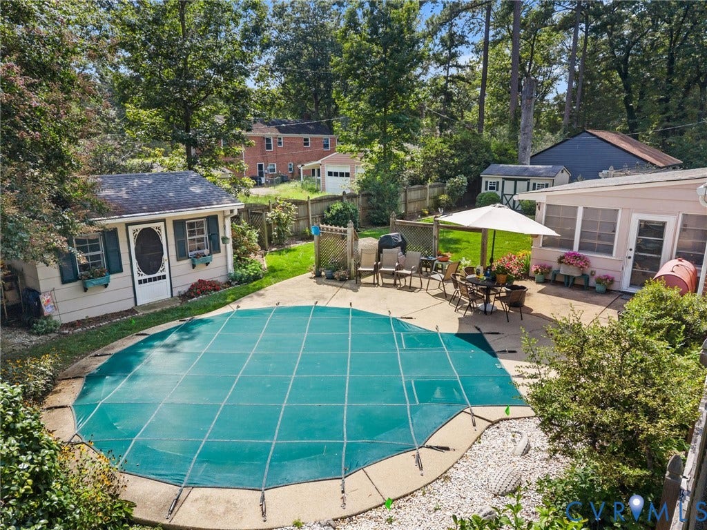 10205 Gwynnbrook Road, Richmond, VA 23235 Outdoor swimming pool with a safety cover, concrete patio, a detached shed with window boxes, and a screened-in porch