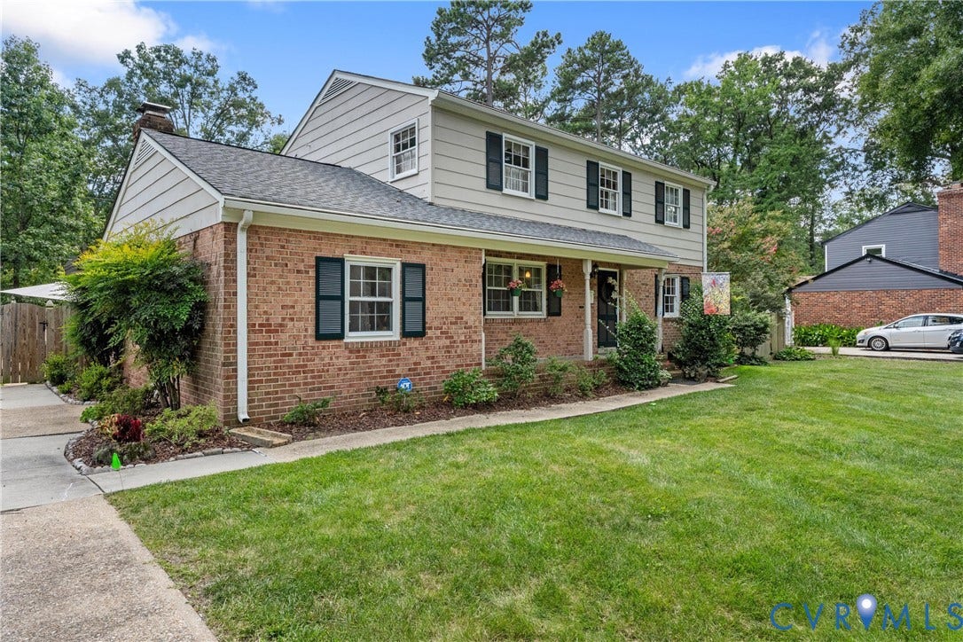 10205 Gwynnbrook Road, Richmond, VA 23235 Traditional two-story residence featuring brick and siding exterior, a covered front porch, and a paved walkway