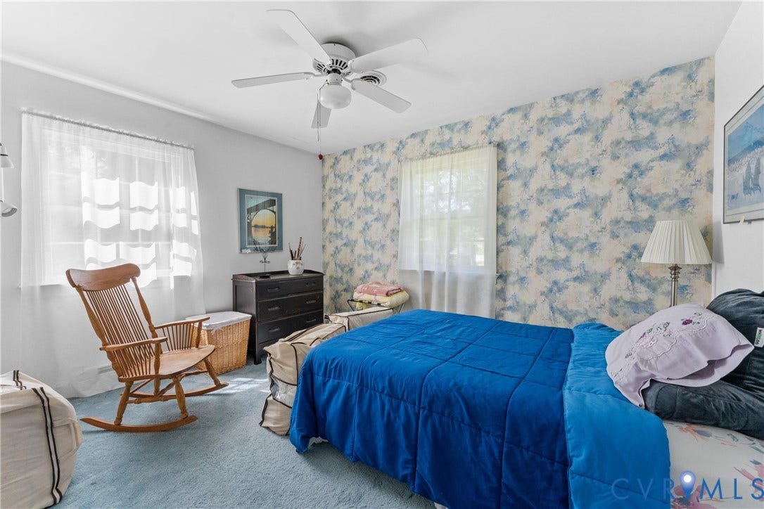 10205 Gwynnbrook Road, Richmond, VA 23235 Textured wall covering accent, ceiling fan with integrated lighting, two windows with sheer curtains, light-colored carpeting