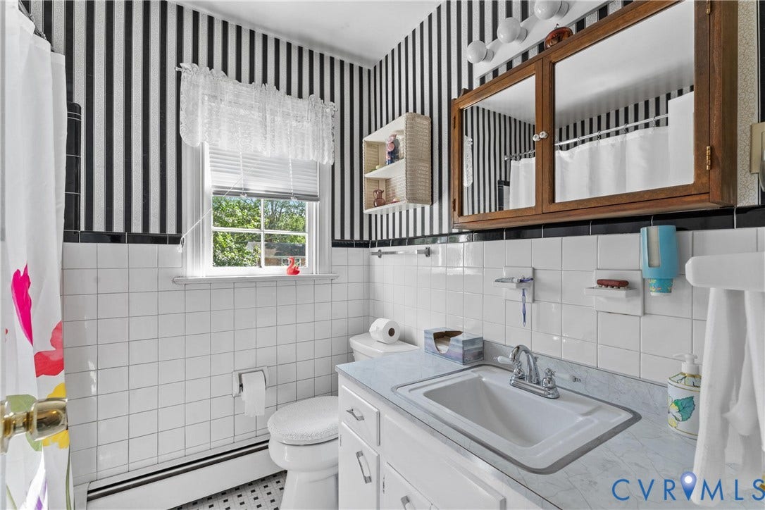 10205 Gwynnbrook Road, Richmond, VA 23235 White tiled walls complemented by a black and white striped accent wall