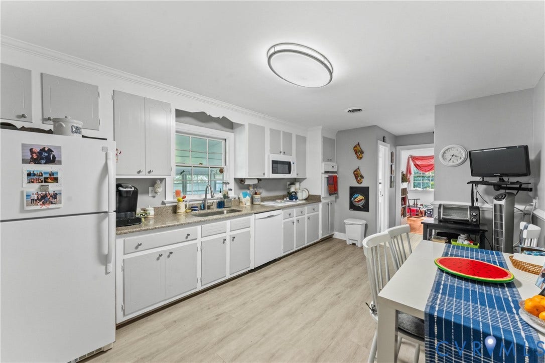 10205 Gwynnbrook Road, Richmond, VA 23235 Kitchen featuring wood-finish flooring, light-toned cabinetry, light-toned countertops, a window over the sink, and ceiling-mounted lighting