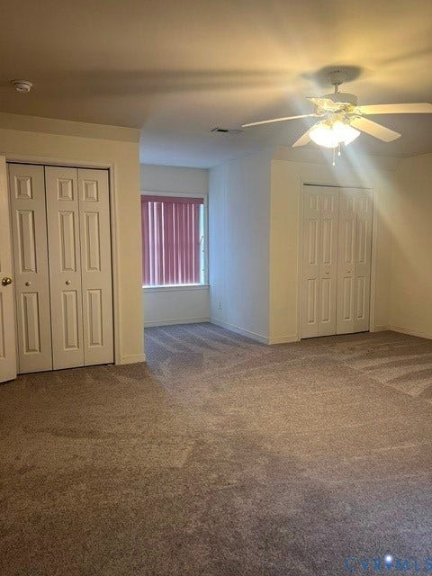 11419 Courthouse Acres Drive, Midlothian, VA 23114 Carpeted room featuring a ceiling fan with integrated lighting, two sets of bi-fold closet doors, and a window with vertical blinds