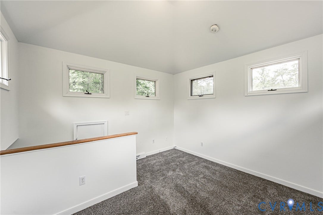 1520 Willow Brook Road, Louisa, VA 23024 Neutral tone wall paint, contemporary carpet flooring, multiple casement windows, and a wood-finish handrail