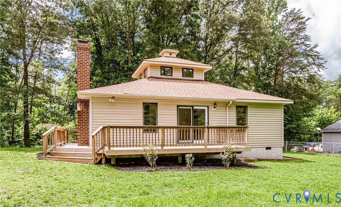 1520 Willow Brook Road, Louisa, VA 23024 Exterior featuring a large wooden deck, brick chimney, light-colored siding, and a multi-tiered roofline with a cupola