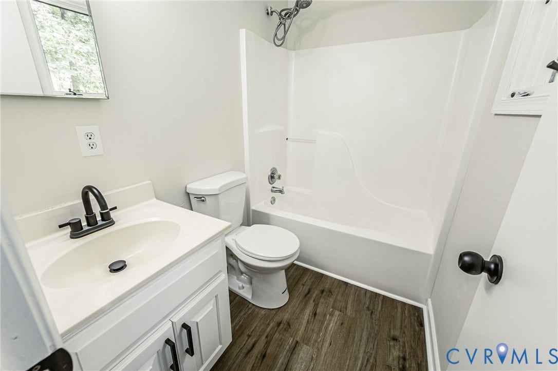 1520 Willow Brook Road, Louisa, VA 23024 White vanity with black hardware and faucet, white countertop, and a white shower-tub combination