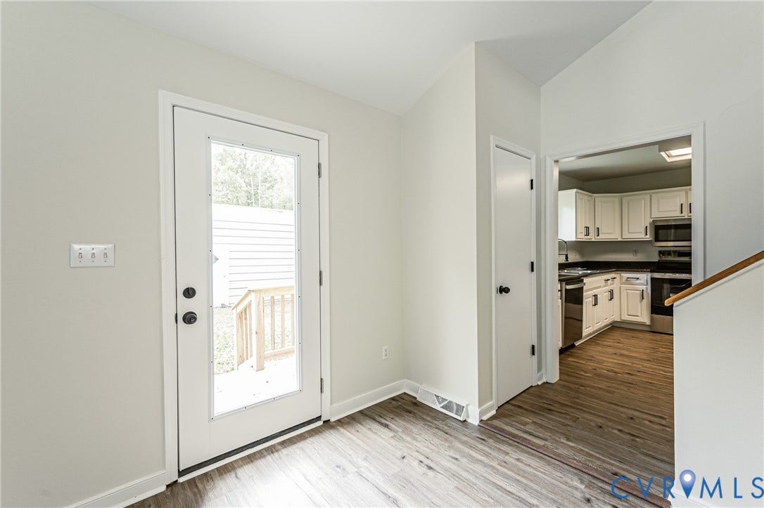 1520 Willow Brook Road, Louisa, VA 23024 Full-lite exterior door with dark hardware, offering access to an outdoor deck with wood railings
