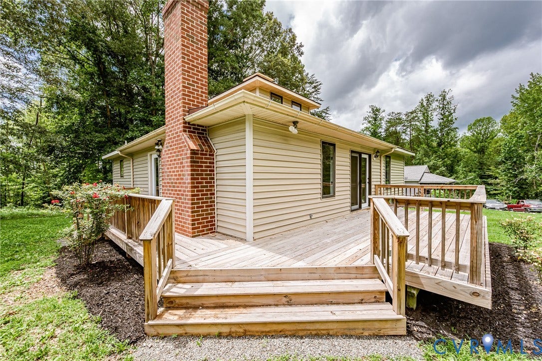 1520 Willow Brook Road, Louisa, VA 23024 Expansive wood deck with stairs, siding exterior, and a prominent brick chimney