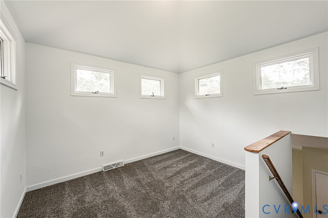 1520 Willow Brook Road, Louisa, VA 23024 Wall-to-wall carpeting, multiple windows flooded with natural light, white painted walls, and a wood handrail