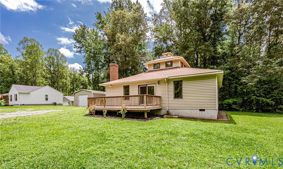 1520 Willow Brook Road, Louisa, VA 23024 Siding exterior with a multi-level roofline, wood deck, and brick chimney