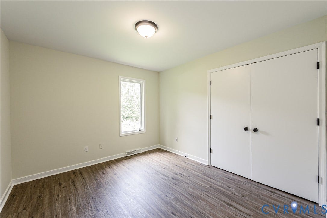 1520 Willow Brook Road, Louisa, VA 23024 LVP flooring, single window, white trim, recessed lighting, and a double-door closet