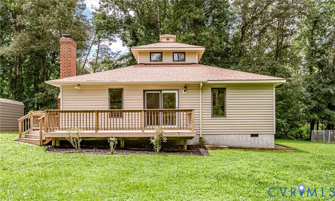 1520 Willow Brook Road, Louisa, VA 23024 Rear exterior featuring light-toned horizontal siding, a red brick chimney, and a multi-level wood deck
