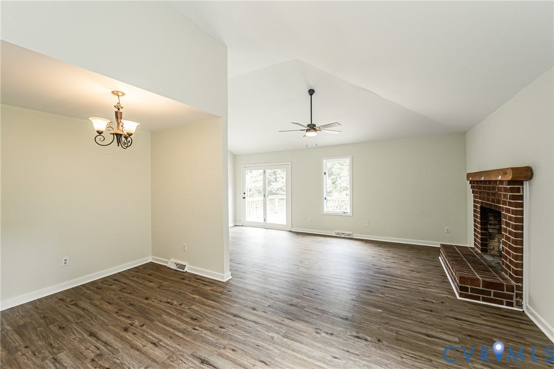 1520 Willow Brook Road, Louisa, VA 23024 Vaulted ceilings, brick-faced fireplace with wood mantel, sliding glass doors, and a ceiling fan