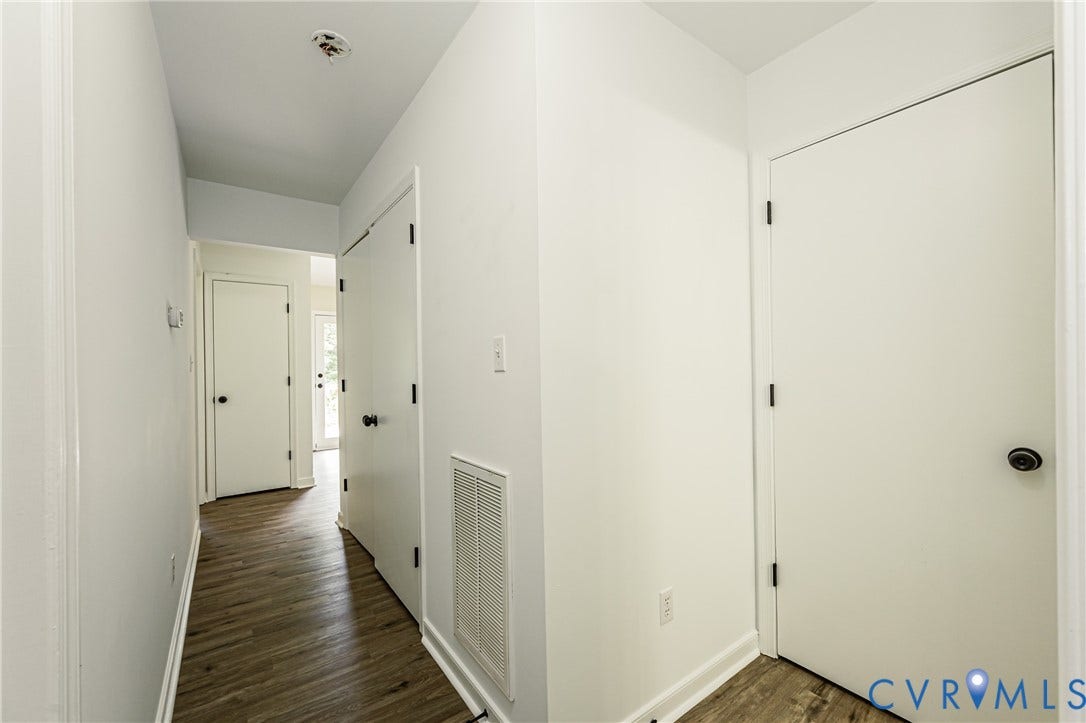 1520 Willow Brook Road, Louisa, VA 23024 Hallway with LVP flooring, white walls, and white doors with black hardware