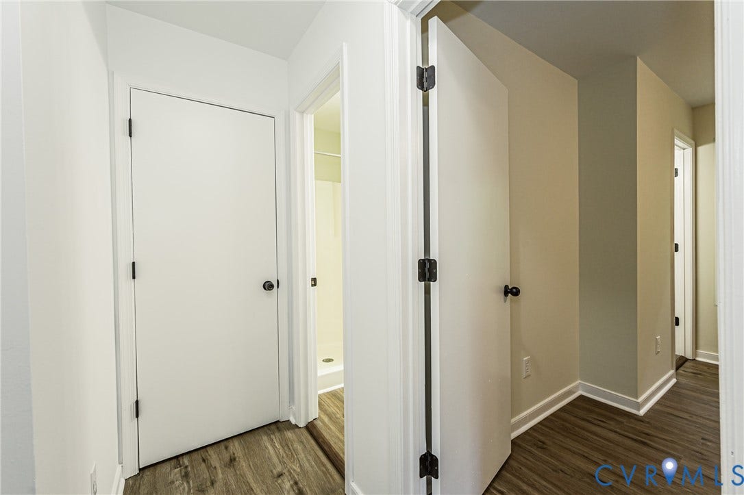 1520 Willow Brook Road, Louisa, VA 23024 Hallway entry to bathroom with LVP flooring, white doors, and painted walls