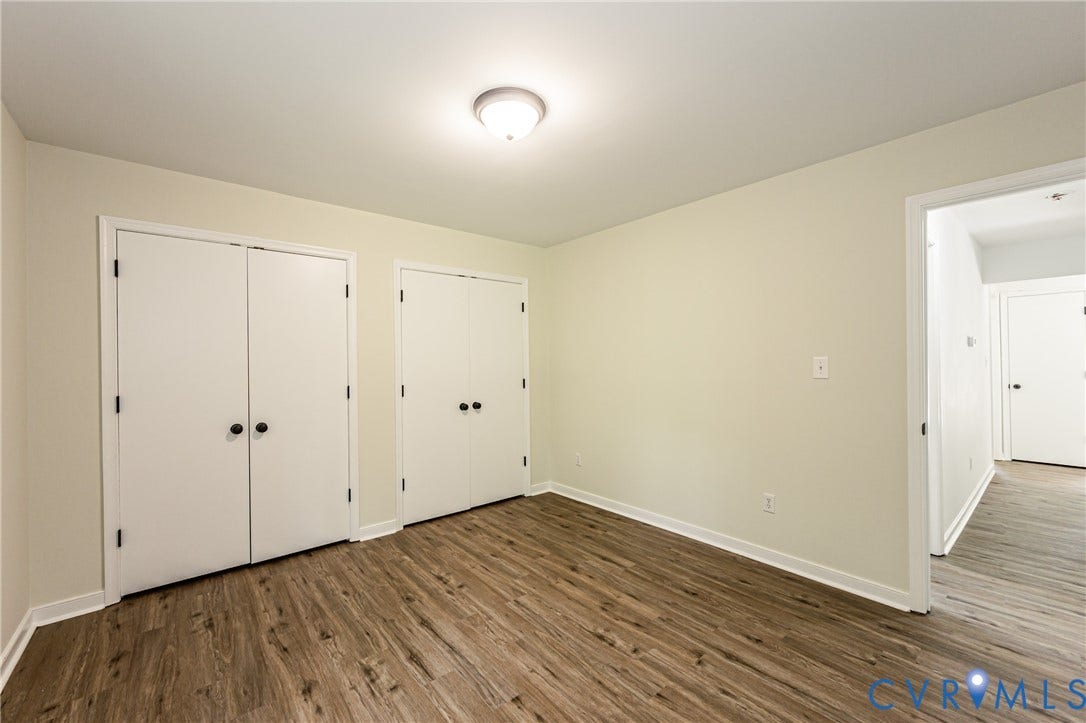 1520 Willow Brook Road, Louisa, VA 23024 LVP flooring throughout, white walls, and built-in closet storage with bi-fold doors