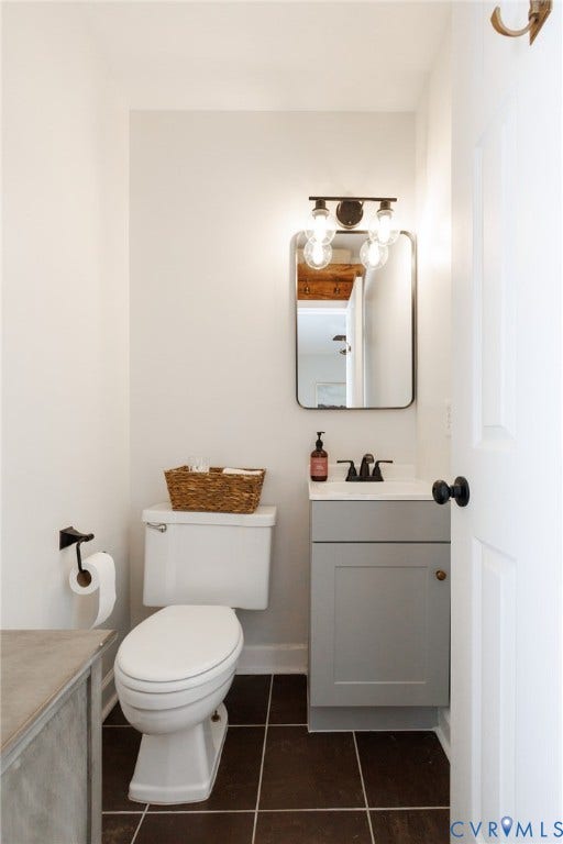 15525 Saddlebrook Road, Chesterfield, VA 23838 White vanity with a neutral-toned cabinet, matte black faucet, and a rectangular mirror
