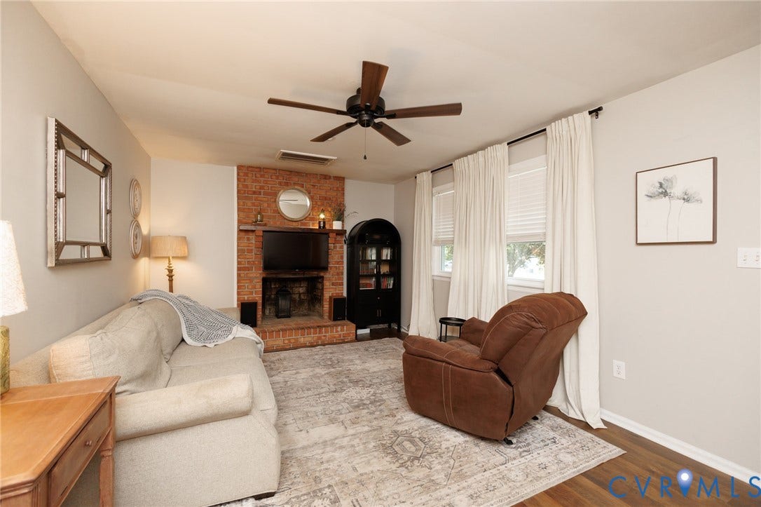15525 Saddlebrook Road, Chesterfield, VA 23838 Living area featuring a brick fireplace with a wood mantle, wood-finish flooring, and multiple windows
