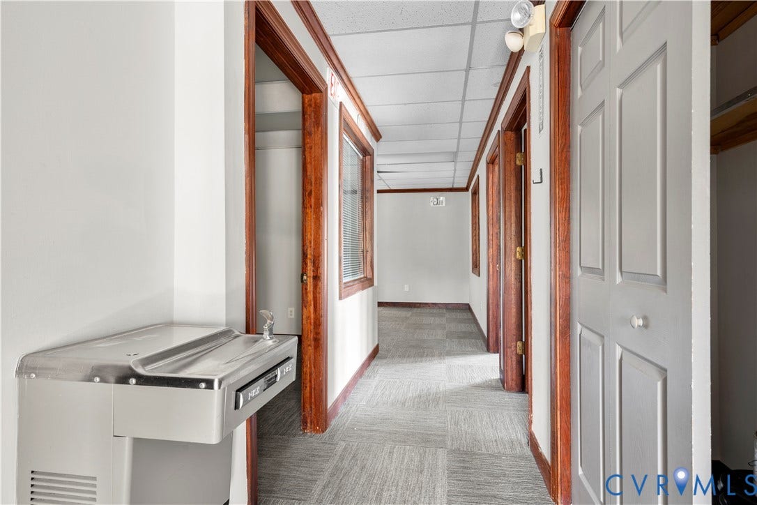 221 Ruthers Road, Richmond, VA 23235 Hallway featuring wood-trim door frames, paneled doors, and square-patterned carpet flooring