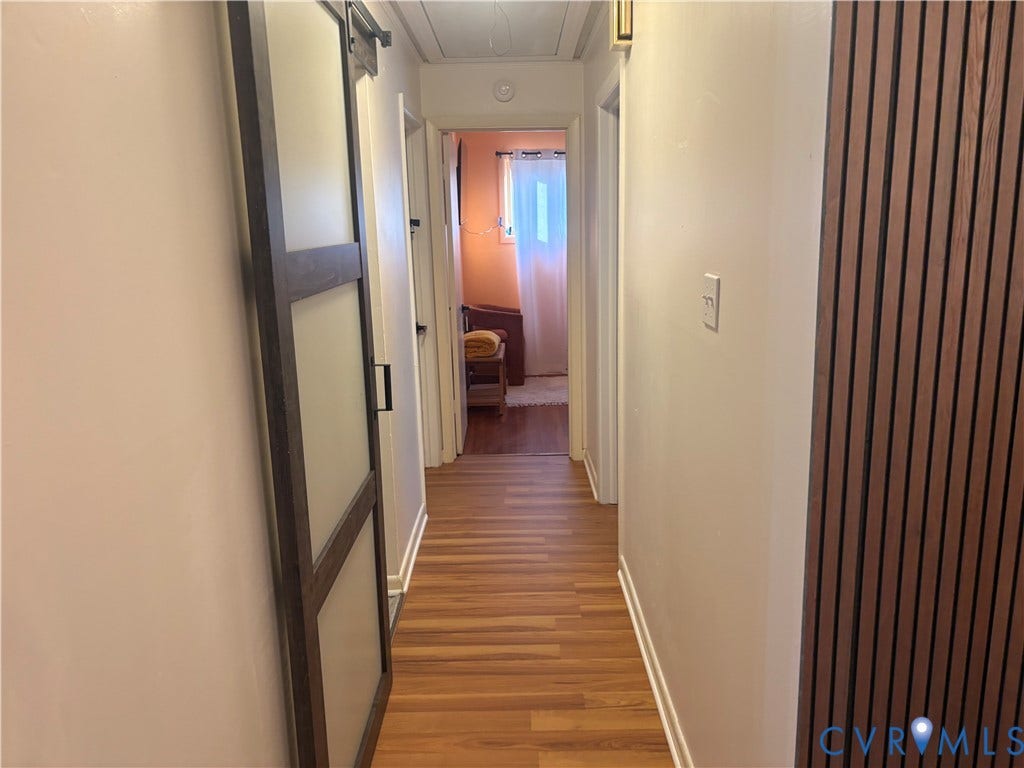 2443 Tignor Road, Richmond, VA 23224 Hallway featuring warm wood-finish flooring, neutral wall finishes, and recessed ceiling lighting