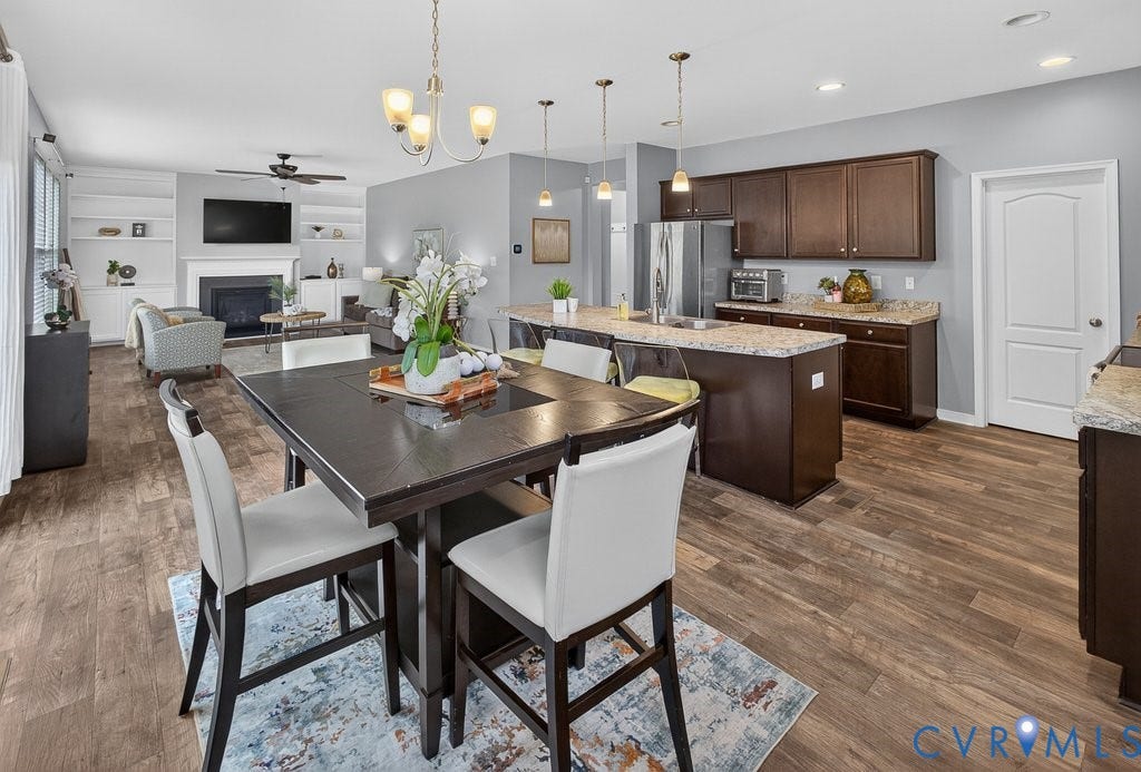 7401 Nicklaus Circle, Moseley, VA 23120 Kitchen featuring dark wood-finish cabinetry, light-toned countertops, and stainless steel appliances