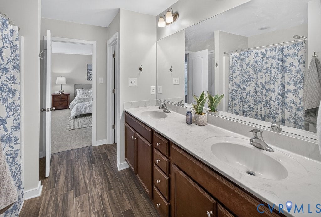 7401 Nicklaus Circle, Moseley, VA 23120 Dual sink vanity with wood-finish cabinetry and light-toned countertops