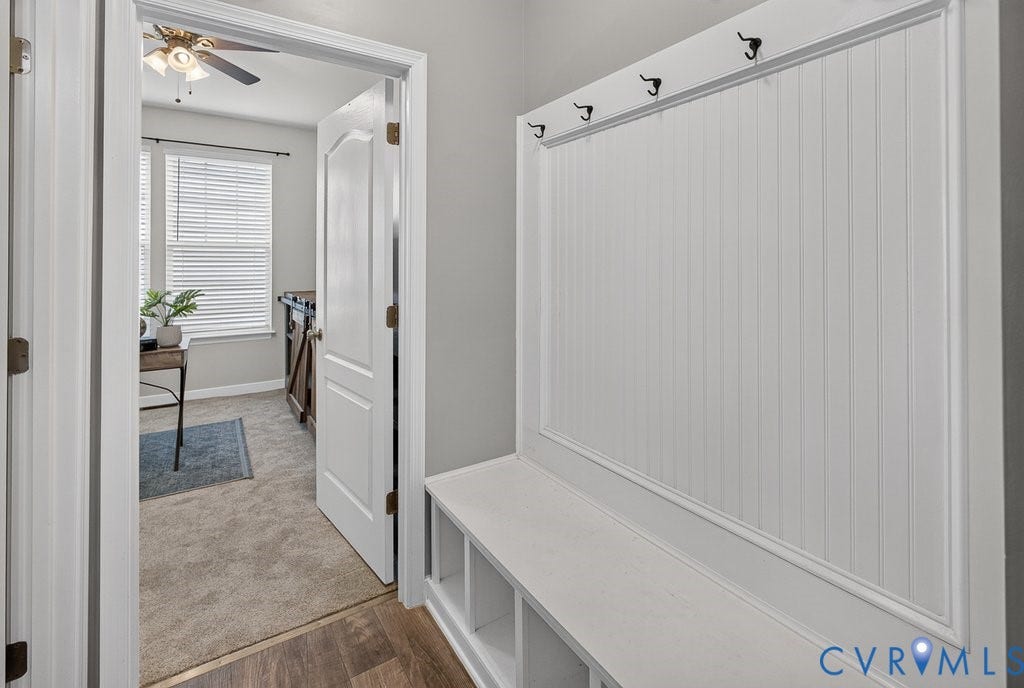 7401 Nicklaus Circle, Moseley, VA 23120 Built-in storage bench with beadboard paneling and hooks beside the garage door.
