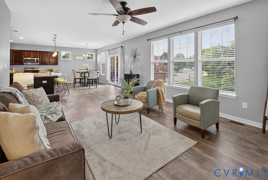 7401 Nicklaus Circle, Moseley, VA 23120 Open-concept living space featuring wood-finish flooring, a ceiling fan, and large windows