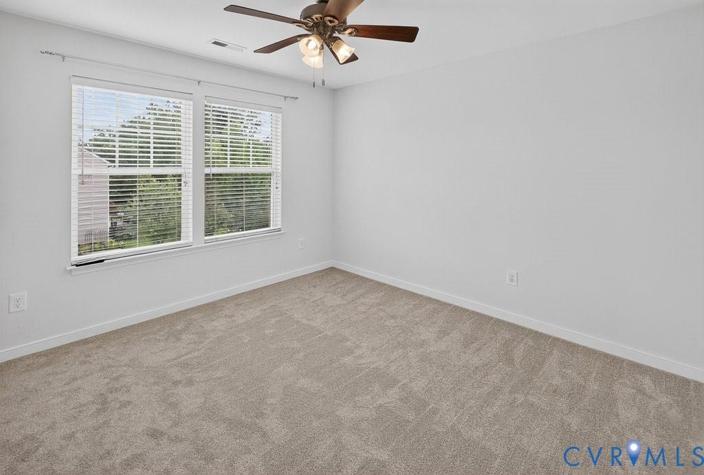 7401 Nicklaus Circle, Moseley, VA 23120 Bedroom 4 -Plush carpeting, two large windows with blinds, a ceiling fan with integrated lighting, and white painted walls