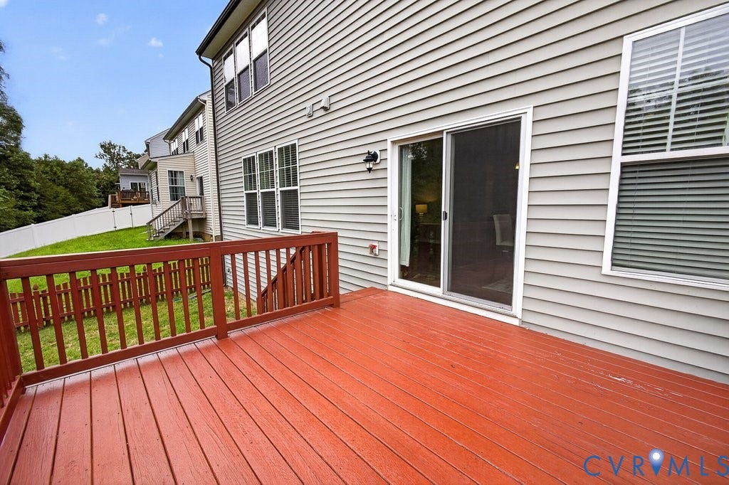 7401 Nicklaus Circle, Moseley, VA 23120 Expansive wood-finish deck with a wood railing, siding exterior, and sliding glass door access