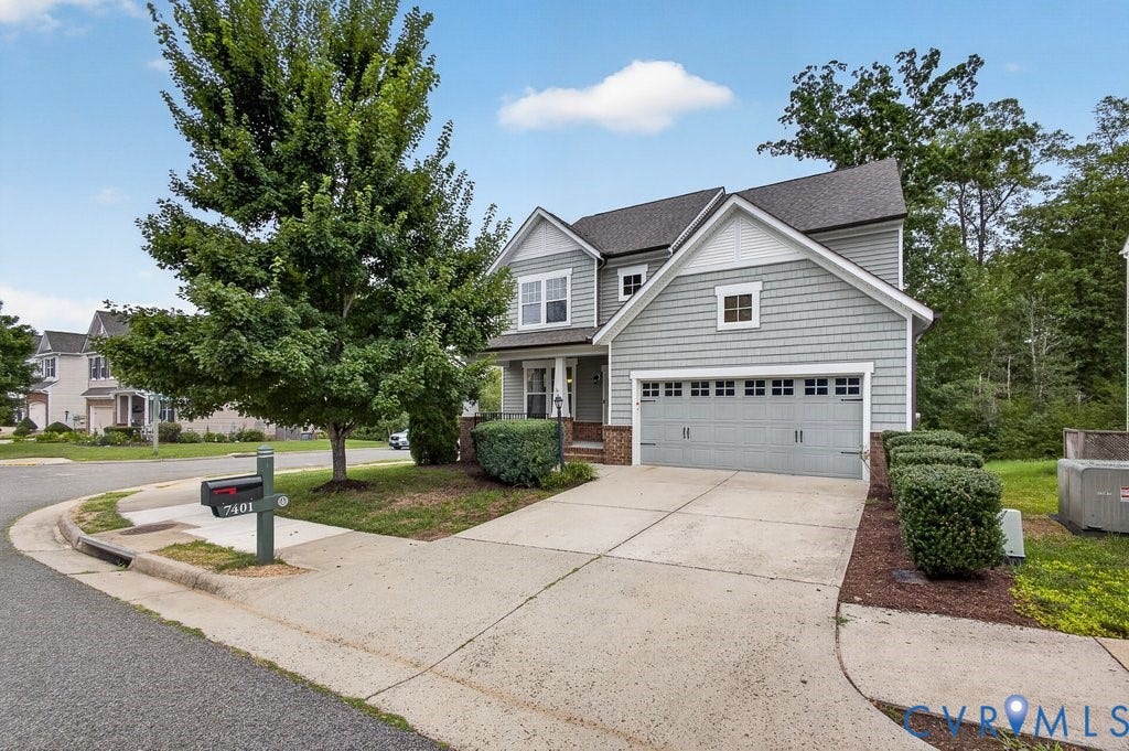 7401 Nicklaus Circle, Moseley, VA 23120 Multi-level siding exterior with brick accents and a two-car garage