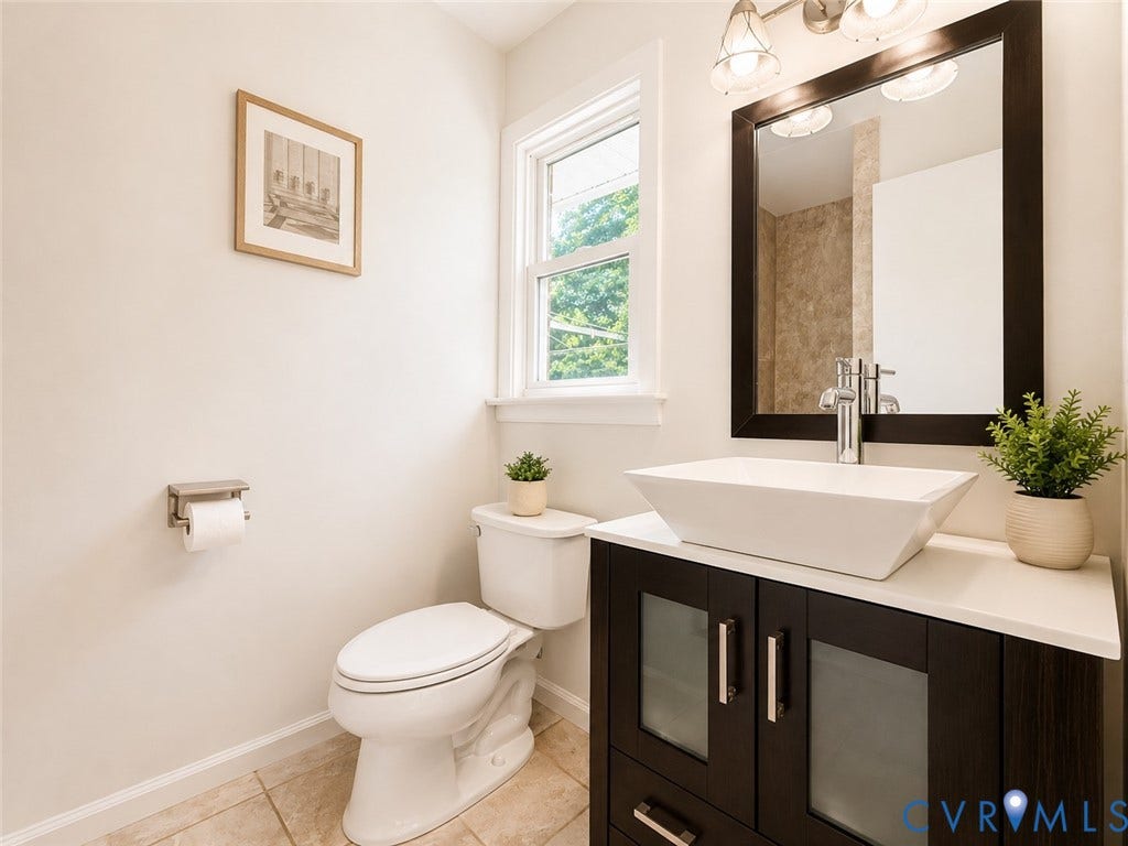 9018 Brucewood Drive, Midlothian, VA 23235 Modern vanity with a rectangular vessel sink, dark wood-finish cabinetry, and a chrome faucet