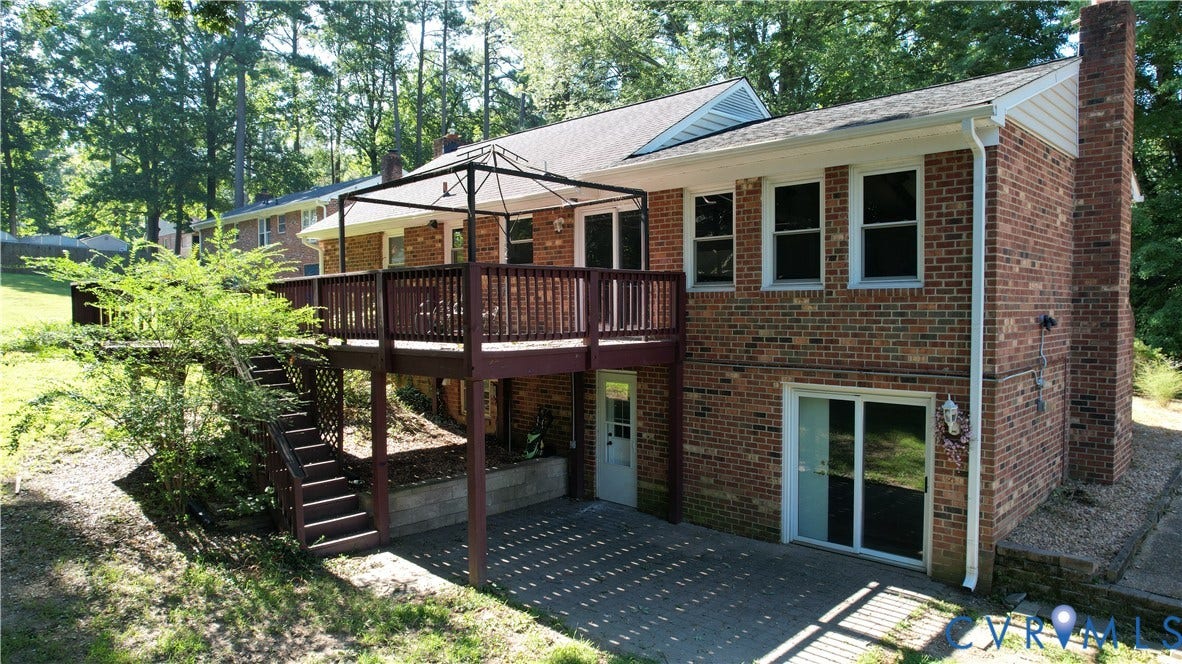 9018 Brucewood Drive, Midlothian, VA 23235 Multi-level exterior with brick siding, a raised deck, and a lower-level concrete patio