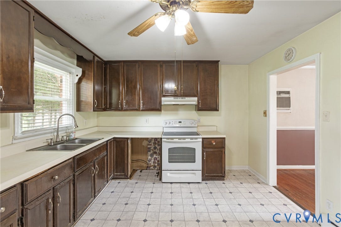 2730 Kinvan Road, Henrico, VA 23231 Kitchen with wood cabinetry, light-colored countertops, dual basin stainless steel sink, white range, and geometric pattern flooring