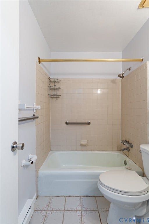 2730 Kinvan Road, Henrico, VA 23231 Bathtub with neutral-toned tiled surround, chrome shower fixtures, and a grab bar