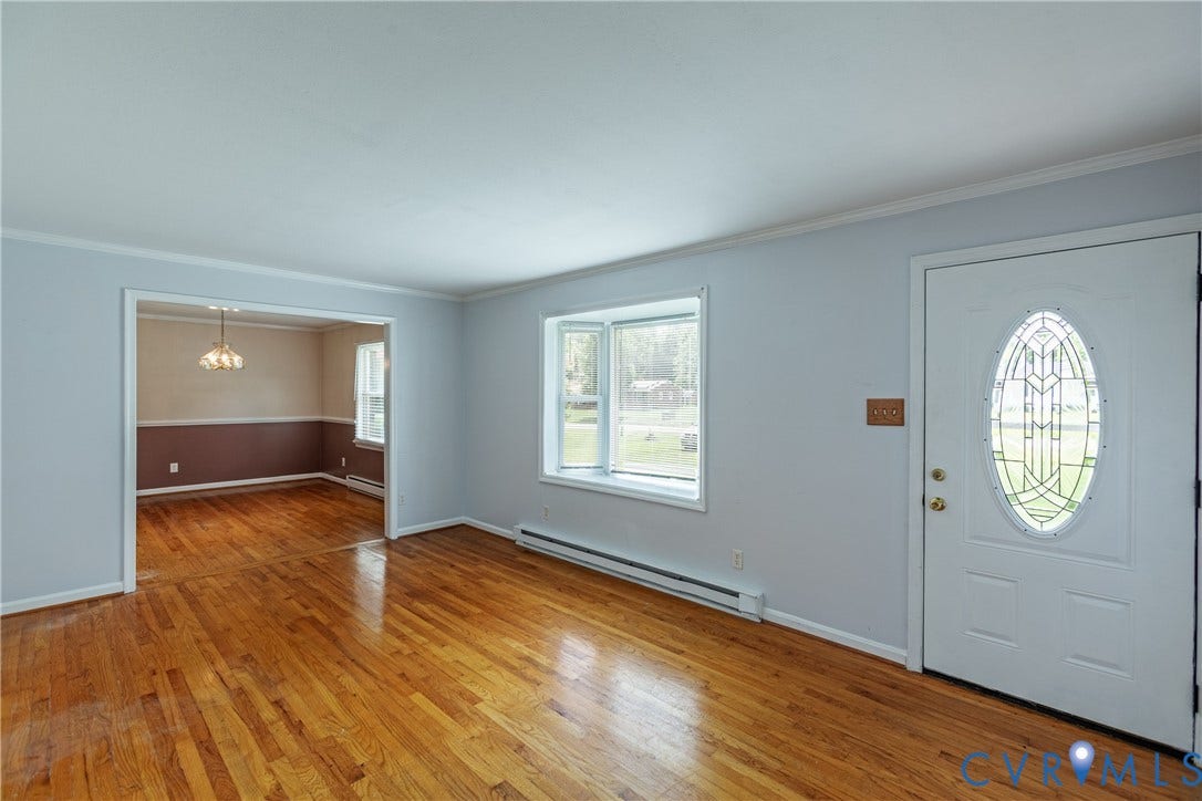 2730 Kinvan Road, Henrico, VA 23231 Hardwood flooring throughout, bay window with exterior scenery, paneled entry door with decorative glass inlay, and crown molding