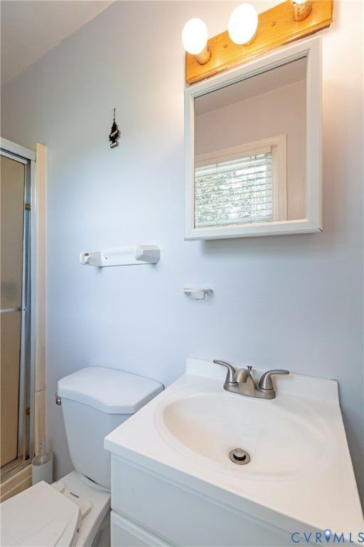 2730 Kinvan Road, Henrico, VA 23231 White vanity with an integrated sink and brushed nickel faucet, paired with a wall-mounted mirror and vanity lighting