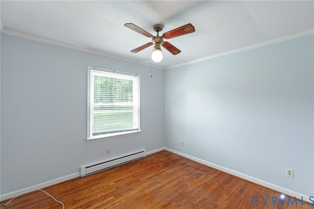2730 Kinvan Road, Henrico, VA 23231 Light blue painted walls, wood-finish flooring, white window trim, and a ceiling fan with integrated lighting