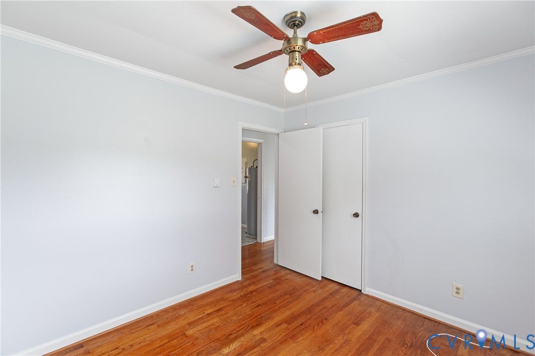 2730 Kinvan Road, Henrico, VA 23231 Hardwood flooring, painted walls, ceiling fan with light fixture, and bifold closet doors