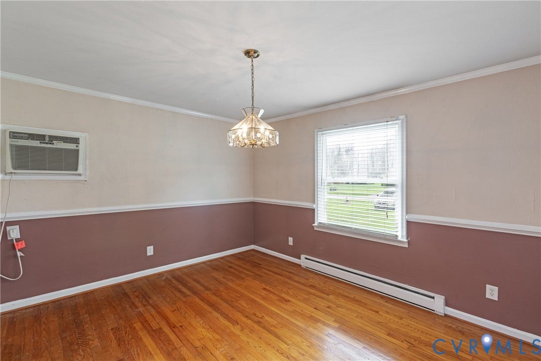 2730 Kinvan Road, Henrico, VA 23231 Hardwood flooring, decorative chandelier, window with blinds, wall-mounted air conditioning unit, and baseboard heating unit