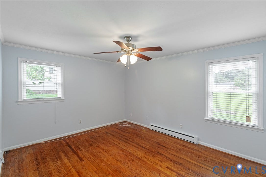 2730 Kinvan Road, Henrico, VA 23231 Hardwood flooring, light gray wall finish, two windows with blinds, ceiling fan with integrated lighting, and white crown molding