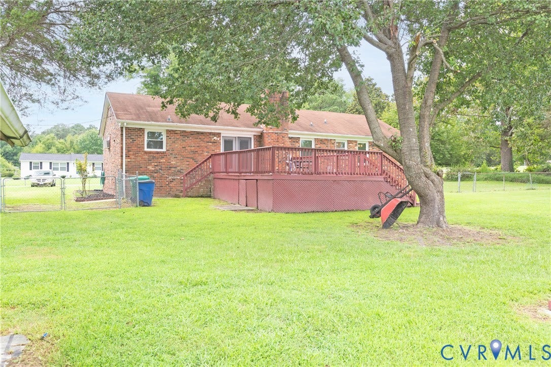 2730 Kinvan Road, Henrico, VA 23231 Brick exterior with a large red-stained wooden deck featuring railings and stairs