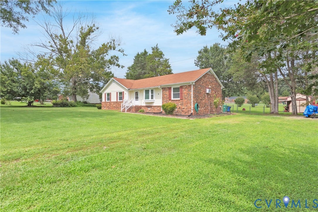2730 Kinvan Road, Henrico, VA 23231 Single-story residence featuring a brick and siding exterior, white porch railing, and a red shingle roof