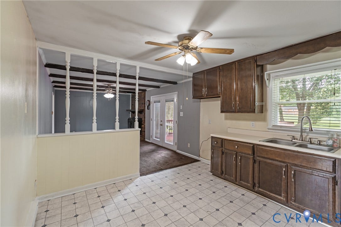 2730 Kinvan Road, Henrico, VA 23231 Kitchen featuring wood-finish cabinetry, a double basin sink, and a multi-pane window