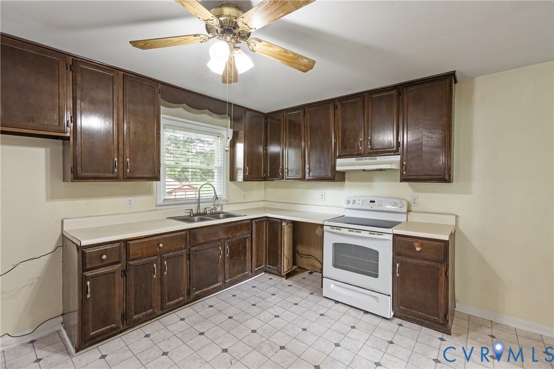 2730 Kinvan Road, Henrico, VA 23231 L-shaped kitchen with wood-finish cabinetry, light-toned countertops, and geometric tile flooring
