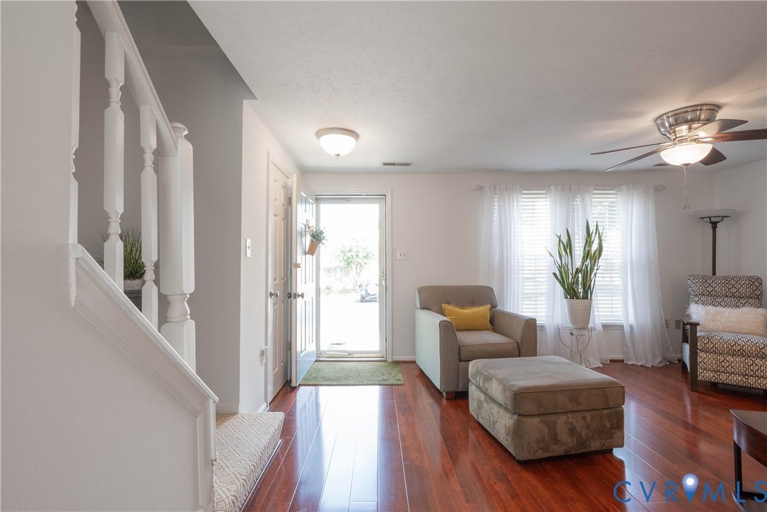 Living Room with floors and ceiling fan with light