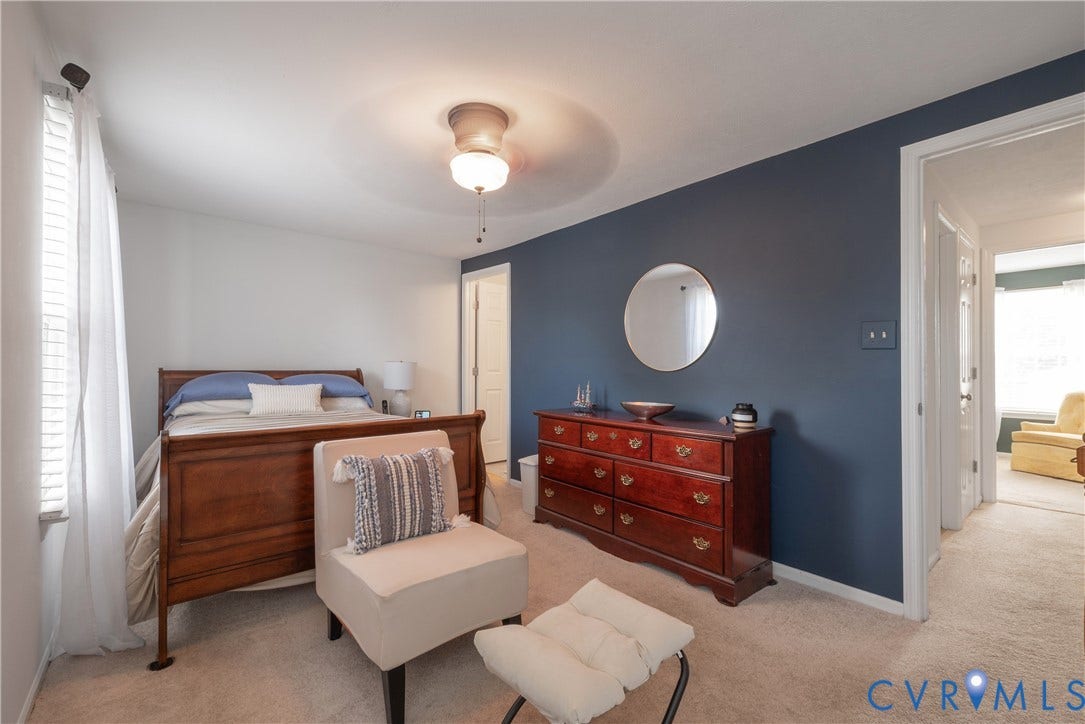 Ceiling fan with integrated lighting, wall-to-wall carpeting, and a window with blinds