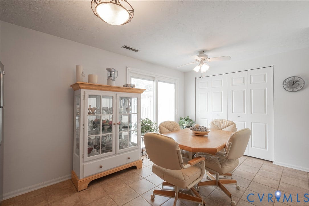 Tiled flooring, white ceiling fan, sliding glass door, white bi-fold doors, and recessed lighting